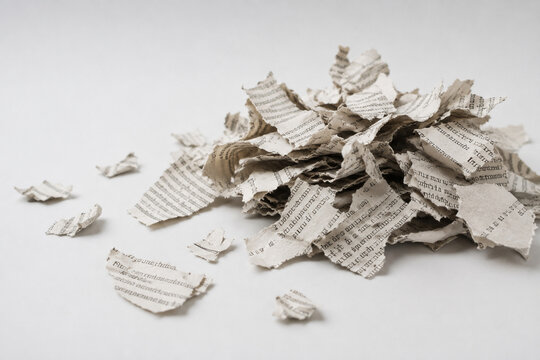 AI generated pile of torn newspaper paper scraps printed text clean white background representing waste recycling information destruction discarded media