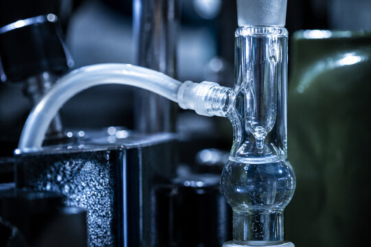 AI generated laboratory glass apparatus clear liquid tubing reflective surfaces representing scientific research chemistry experiments technology industrial analysis