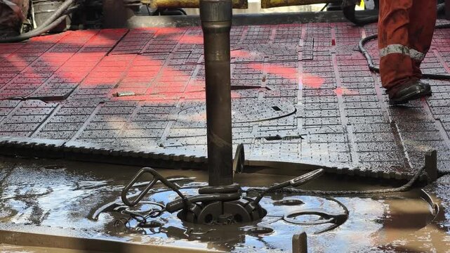 Rig crew perform pulling of of hole drill string with oil based mud on the rig floor. Trip out of hole.