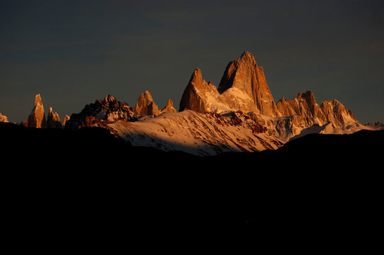 Famous Mount Fitz Roy glowing at sunset above snowy peaks in El Chalt&eacute;n, Patagonia, Argentina.
