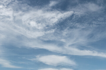 Obraz premium blue sky with a dramatic scattering of white clouds. blue sky background.