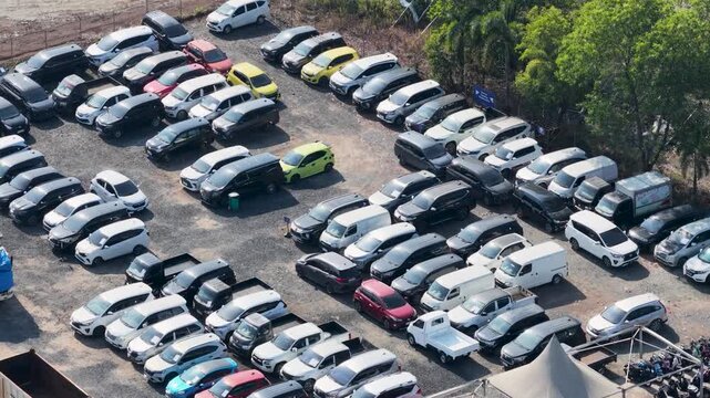 Rows of parked vehicles packed in an outdoor lot on a sunny day in Banjarbaru South Kalimantan