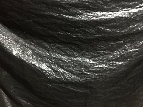 Black plastic bag texture background, dark black garbage platic bag