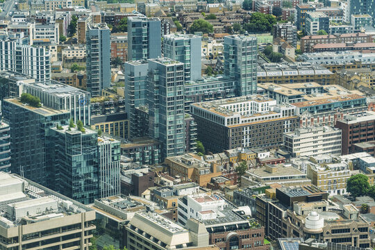 View of the modern London skyline featuring glass skyscrapers, historic brick buildings, and urban density in London, England, United Kingdom.