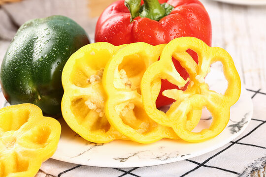 Fresh Colorful Bell Peppers - Yellow Red Green Vegetables with Water Droplets on Cutting Board