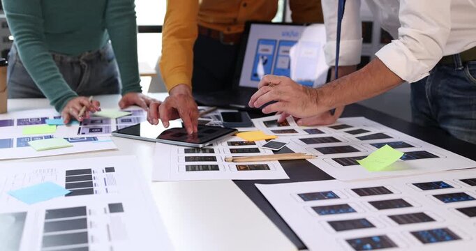 Design team collaborating on user experience and interface development, prototyping mobile application layouts