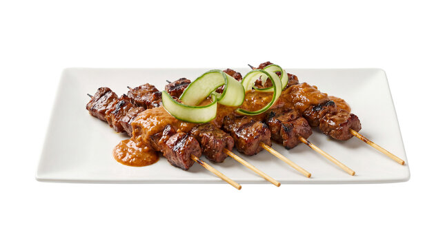Thai Satay Chicken Skewers with Peanut Sauce, Garnished with Cucumber Slices on a White Rectangular Plate, Gourmet Asian Street Food Photography, High Quality Culinary Detail