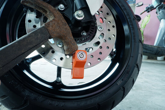 ​Motorcycle Theft Attempt with Hammer Hitting Disc Brake Lock for Security Test and Protection Concept