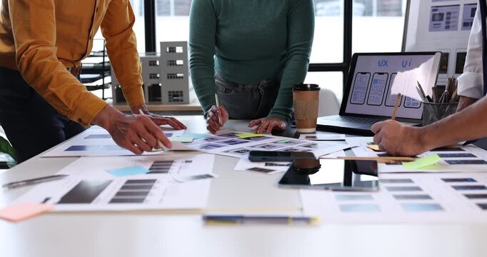 Design team collaborating on user experience and interface development, prototyping mobile application layouts