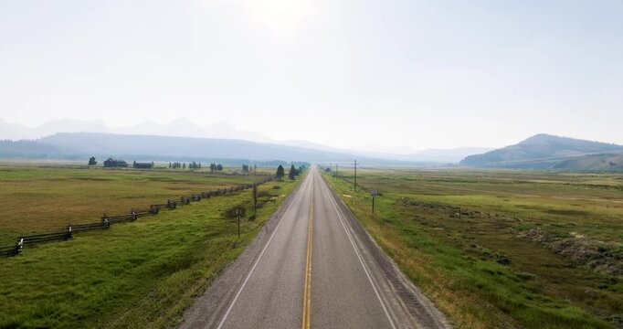 Straight road through open fields
