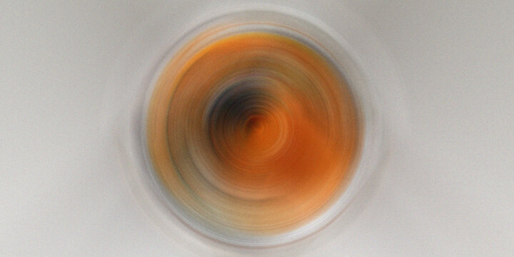 Abstract orange vortex creating dynamic colorful radial effect background.