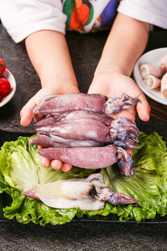 Fresh Whole Squid and Cuttlefish Seafood from Shandong China Held by Chef Hands for Cooking