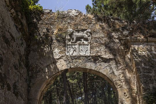 View of the historic Venetian stone archway featuring a relief carving of the Lion of Saint Mark in Zakinthos, Greece.