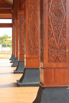 Row Of Carved Wooden Pillars In Traditional Javanese Architecture