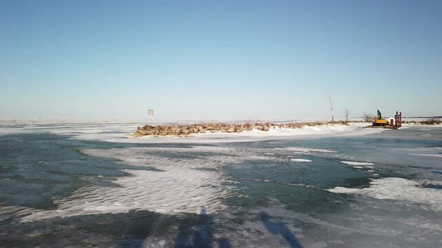 Belle River Marina, in the Lakeshore municipality of Ontario, Canada. Located on southern shore Lake St. Clair, a minor Great Lake frozen over during a cold winter late afternoon in February, 2022.