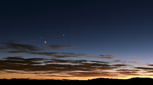 Planetary Alignment Visible in Twilight Sky Over Silhouetted Landscape
