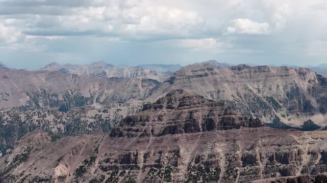 Aerial of Uinta Wasatch Cache National Forest rugged mountain range view in Utah with layered cliffs and canyons under an overcast sky in summer