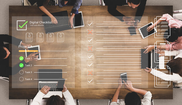 Collaborative Teamwork with Digital Checklist Over Table in Modern Office with Laptops and Tablets for Project Management and Organization. Glyphic.