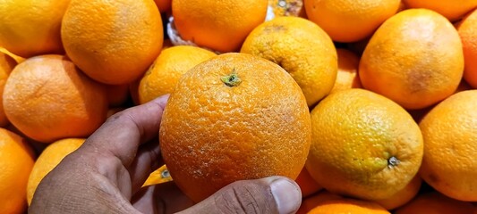 Vibrant fresh lemons displayed for sale at fruit market vendor stall under bright natural light © EfendyA