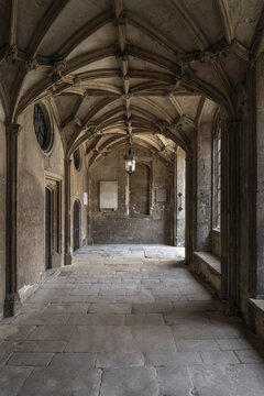 Oxford, United Kingdom - 24 July 2026: View of the historic stone cloister with vaulted ceilings, flagstone flooring, and a hanging lantern in Oxford, England.