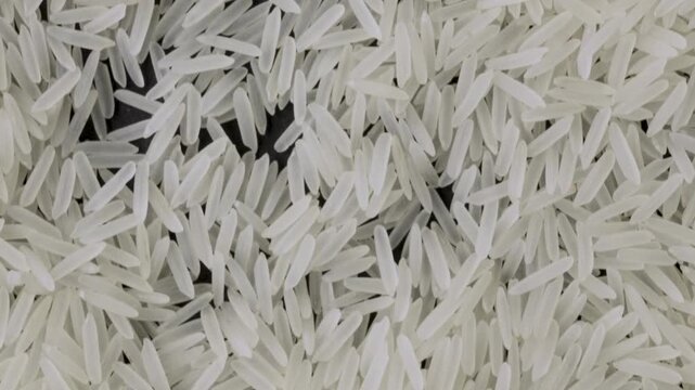White basmati rice grains macro camera panning down handheld shot, FHD