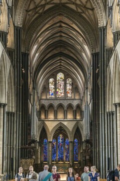Salisbury, United Kingdom - 23 July 2026: View of the interior of Salisbury Cathedral with its soaring Gothic arches, intricate stained glass windows, and visitors walking through the nave.