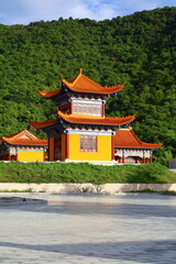 Naklejka premium Traditional Chinese Pagoda Temple Surrounded by Green Mountains in Phnom Sruoch, Kampong Speu, Cambodia