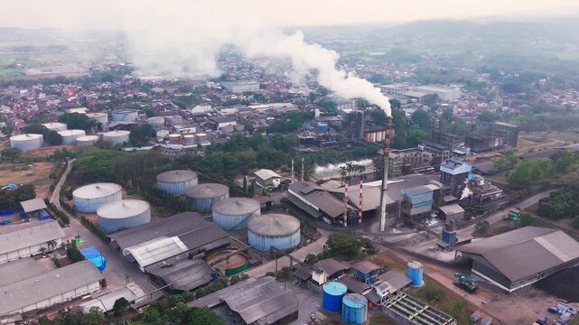 Aerial drone view of an industrial fuel storage terminal in Indonesia, featuring large storage tanks, pipelines, loading facilities, and supporting infrastructure for petroleum products and energy dis