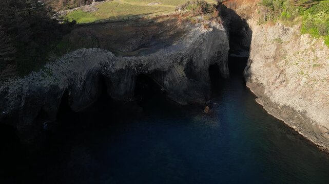 Nanatsugama Cliffs in Saga, Japan &mdash; Dramatic Aerial Drone View of Basalt Sea Cliffs and Caves on the Genkai Sea