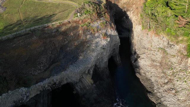 Nanatsugama Cliffs in Saga, Japan &mdash; Dramatic Aerial Drone View of Basalt Sea Cliffs and Caves on the Genkai Sea