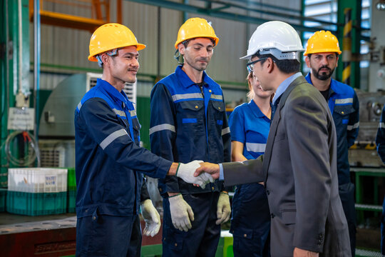 Team of diversity worker inspecting inside steel manufacturing factory while greeting by senior manager advice on improvement of capacity and productivity