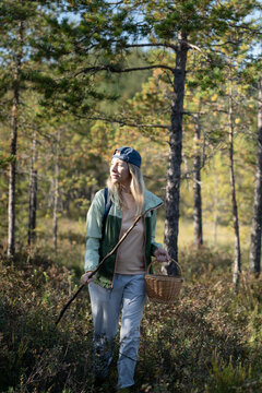 Mature woman strolling through forest, physical activity outdoors and healthy living, female solo hiking in woodlands, walking making way on trekking path in thickets, getaway in nature.