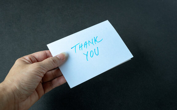Hand holding a thank you card
