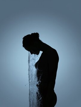 Silhouette of a person reflecting on pollution as water flows into their body symbolizing environmental concerns