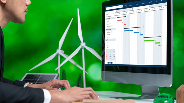 Project planning software for brisk business project management on the computer screen showing timeline chart of the team project