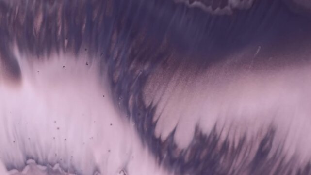 Ripple fantasy. Flowing paint. Defocused purple color liquid chemical texture foam milky fluid on abstract art acrylic background.