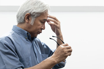 Asian elderly senior man with eyesight issue, concept image of aging eye sight, vision deterioration, cataract, glaucoma, eyesight impair, eye care, head and shoulder side profile portrait © 9nong