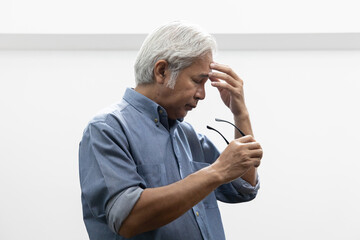 Asian elderly senior man with eyesight issue, concept image of aging eye sight, vision deterioration, cataract, glaucoma, eyesight impair, optical problem, eye care, half-length side profile portrait © 9nong