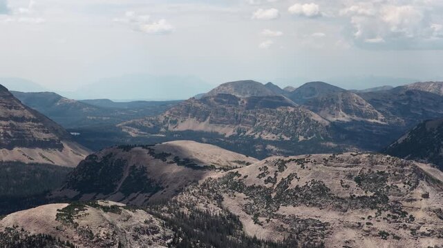 High aerial of rugged mountain landscape in Uintas in Wasatch National Forest in Utah in summer under overcast sky