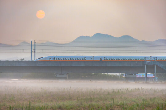 High speed passenger train passes through morning mist in Taiwan