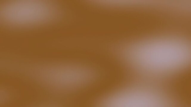 A soft-focus abstract image featuring a blend of brown and pink hues, creating a smooth and calming texture with no distinct shapes or objects.