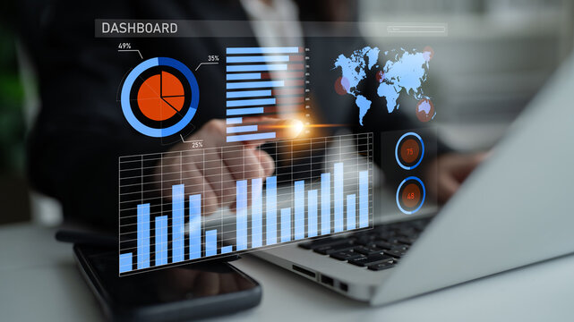 A business professional engages with a digital dashboard on a laptop, showcasing interactive graphs and data visualizations in a modern office setting. Highly effective for presentations. Impute