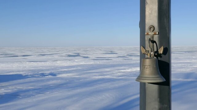 Sea bell at Belle River, a small town in the Lakeshore region of Ontario, Canada. Southern shore of Lake St. Clair, a minor Great Lake frozen over during a cold winter afternoon in February, 2022.