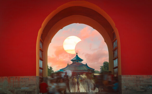 Temple of Heaven in Beijing through red archway with conceptual solar eclipse and copy space