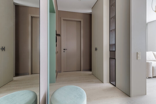 Modern Apartment Hallway Interior with Wardrobes and Fluted Door