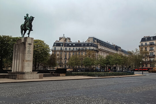 Paris, France - 01 April 2026: View of the equestrian statue of Ferdinand Foch in a square surrounded by historic Parisian buildings under a cloudy sky.