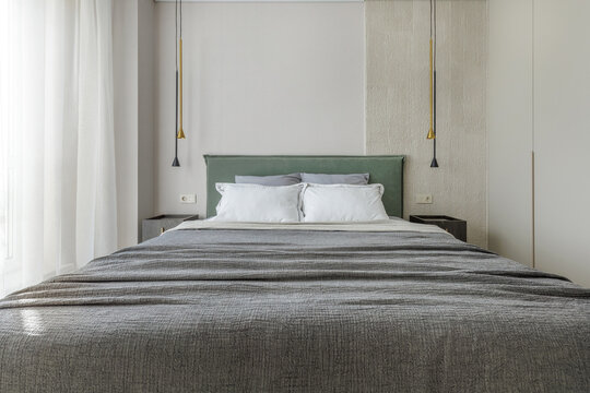Modern Bedroom Interior Design with Green Headboard and Pendant Lights