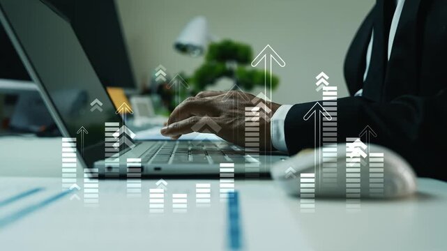 Businessman working on computer with holographic arrow graph bar on the screen, Close-up of a business person typing on a laptop at a desk with hologram digital growth charts and upward arrows