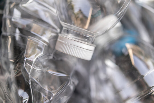 empty clear plastic water bottles in recycling bin for environmental conservation concept