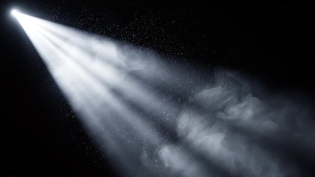 Bright spotlight beam shining through dark atmospheric haze and dust particles on black background